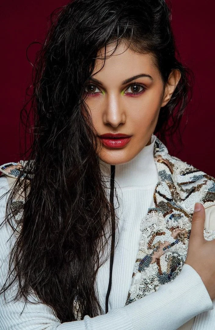 Amyra Dastur posing elegantly in a stylish outfit at a public event.